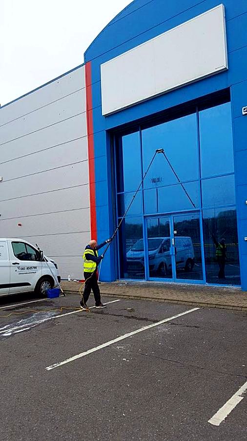 Cleaning tall glazing on a commercial unit from the ground
