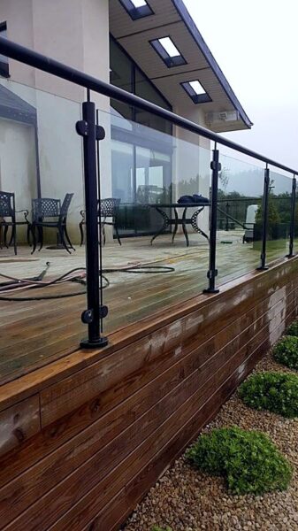 Decking being washed, with the hose on the boards