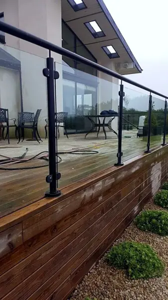 Decking being washed, with the hose on the boards