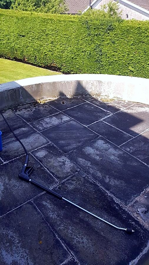 Dark, dirty slate patio before pressure washing