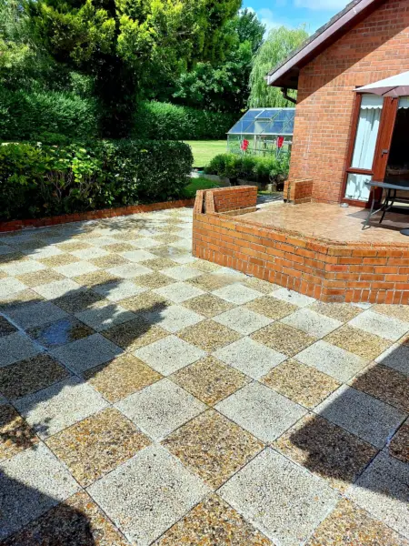 Chequered patio slabs beside a brick house