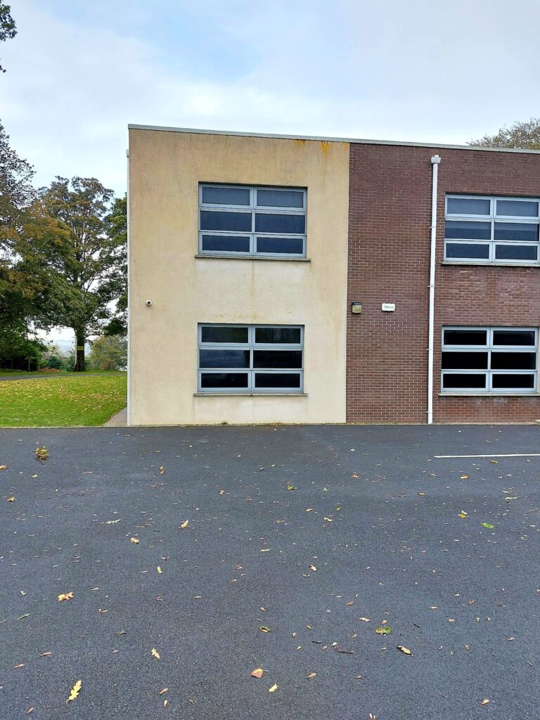 The same commercial building with clean render after cleaning