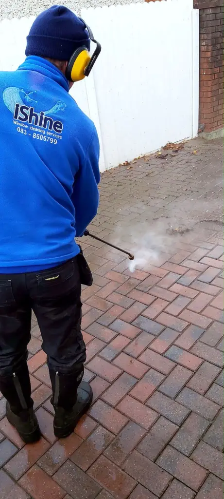 Terry, iShine’s owner/operator, pressure washing a block paving driveway